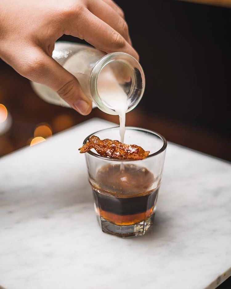 espresso, maple syrup and bacon infused milk coffee drink. with a caramelized bacon garnish.