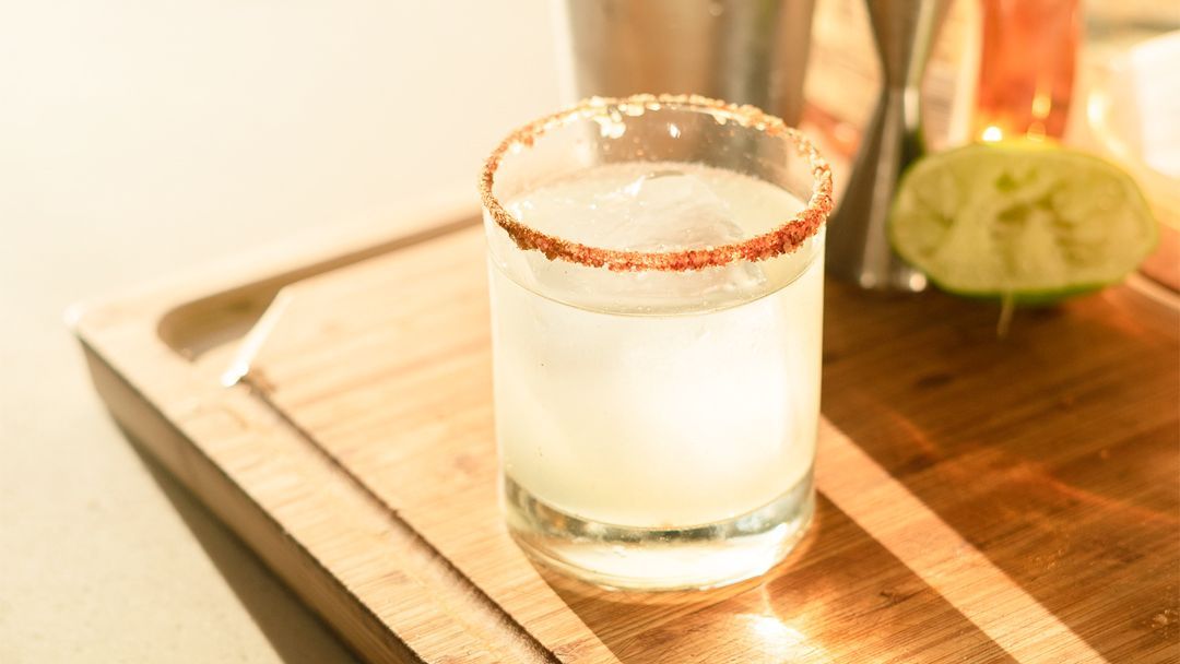 rimmed margarita glass with warm light in the background