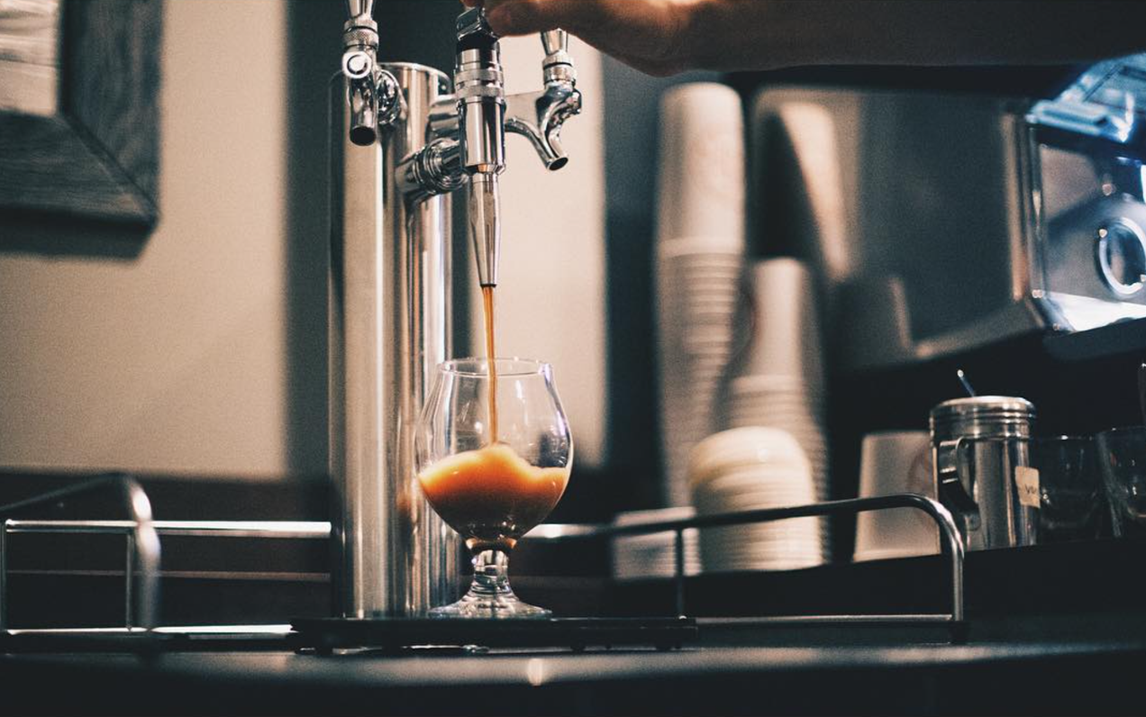 cold brew nitro being dispensed from a kegerator in a coffees